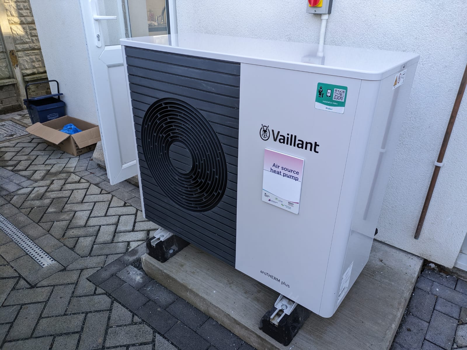 A Vaillant air source heat pump outside a terraced house